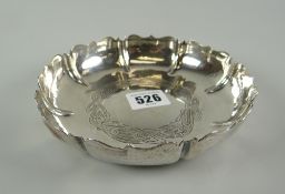 An Irish silver dish formed with border of eight lobes with ogee rims and with engraved Celtic