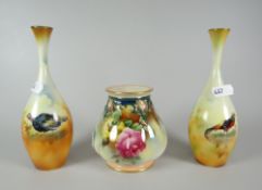 A Royal Worcester footed vase of lobed form and with narrow neck decorated with yellow and pink
