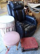 A black leather electric recliner armchair together with a small circular glass topped table and two