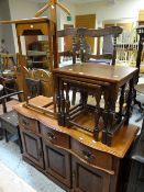 A reproduction serpentine-front sideboard, a nest of three coffee tables, together with a vintage