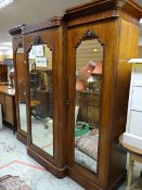 Early nineteenth century triple three glazed door breakfront mahogany wardrobe with carved molding