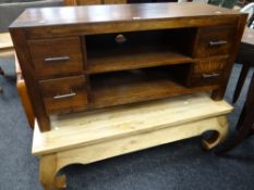 A modern dark wood hi-fi / TV stand with shelves and drawers together with a plank top-style