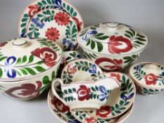 A Llanelly pottery Persian Rose part dinner set including two lidded tureens, dish plates, small