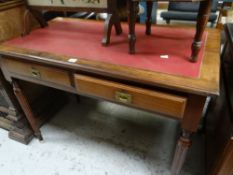 A small mahogany two-drawer writing desk on fluted supports and with red leather insert top,