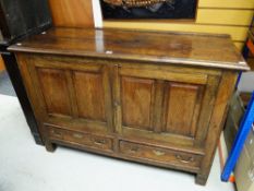 A nineteenth century oak panelled mule chest having two base drawers converted to cupboard with
