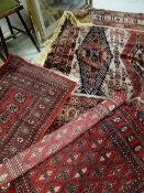 A Persian wool carpet with intricate rust, cobalt blue and brown woven decoration, 210cms wide and