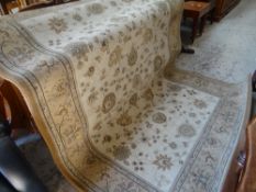 A floral Persian-style carpet, size to follow!, four pine hanging wall racks and a set of four