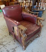 A turn-of-the-century carved club-type chair in buttoned red leather (for repair / re-upholstery)