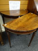 A pair of reproduction inlaid mahogany half-moon hall tables on tapered and reeded supports, 76cms
