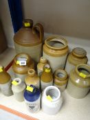 Collection of stone glazed advertising bottles and jars including E E Bevan, Neath, Hurn's Swansea