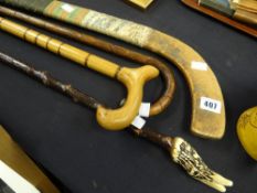 A vintage Indian made hockey stick with stamp marks together with a walking cane, having a silver