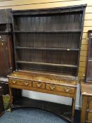 A nineteenth century Welsh dresser of small proportions on delicate supports with three drawers