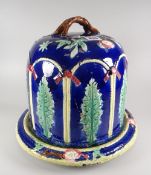 A turn of the century Majolica pottery cheese dome & stand in blue ground with relief decoration and