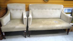 An antique armchair later upholstered with three button back together with matching eight button