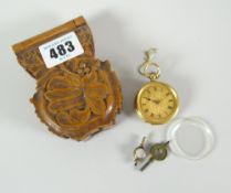 A 9ct gold ladies fob watch in a carved wooden case Condition reports provided on request by email