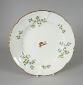 A Swansea porcelain dish of lobed form and decorated with cornflower sprigs and centred armorial