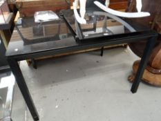 A contemporary black glass extending dining table Condition reports provided on request by email for