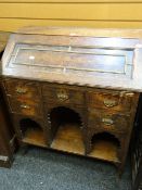 An antique oak pull down kneehole bureau with bank of five drawers Condition reports provided on
