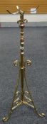 A vintage brass tripod floor standing oil lamp base, 125cms high