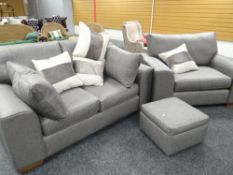 A modern two-piece lounge suite and silver-grey upholstery comprising large armchair, two-seater