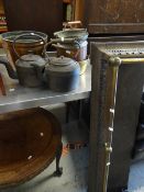 A brass and cast metal antique fender, two old cast iron kettles, a copper kettle and three items of