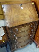 A neat reproduction mahogany narrow serpentine bureau with sloped front and four drawers, 53cms wide