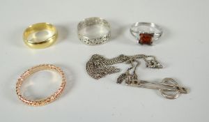 An 18ct gold wedding band, three other rings and a silver necklace Condition reports provided on