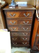 A reproduction narrow chest of six drawers, 44cms wide Condition reports provided on request by