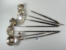 A group of seven silver toddy ladles with whalebone / horn twist handles, each apart from the