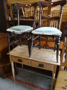 A stripped pine two-drawer side table and a pair of carved chairs Condition reports provided on