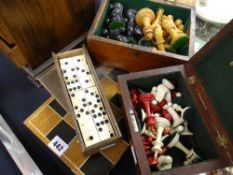 A cased chess set together with two other boxed chess sets and a vintage boxed dominoes set