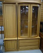 A modern lightwood display cabinet with a three-drawer base and matching side cabinet, 199cms wide