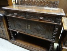 A nineteenth century carved oak buffet sideboard on barley-twist supports, with a base of two