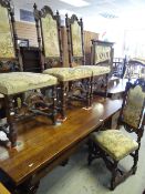 A twentieth century oak refectory-style dining table, 183cms long and six carved tapestry seat and