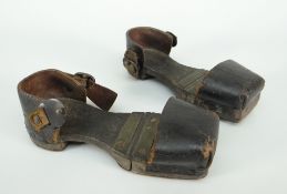 A pair of nineteenth century child's patten / overshoes having wooden hinging soles and leather heel