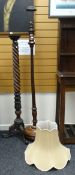 A vintage mahogany circular base reeded standard lamp together with a carved and spiral turned