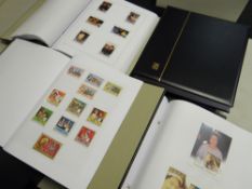A set of four neat Davo cased folders of British stamps Condition reports provided on request by