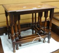 A small nest of three oak coffee tables on turned block supports Condition reports provided on