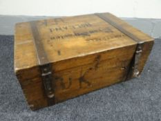 A vintage pine travel trunk with metal mounted banding and iron handles complete with former owner's