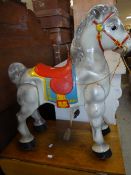 A Sebel Mobo articulated ride along pony in cast metal with red saddle and harnesses and pedals