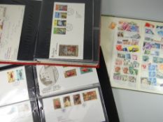 Two albums of first day covers and a green album of loose stamps Condition reports provided on