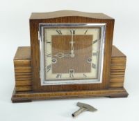 An early to mid twentieth century Art Deco wooden encased mantel clock with square dial bearing