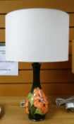 A green ground Moorcroft slipper orchid patter table-lamp & shade Condition reports provided on