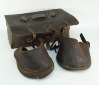 A pair of antique leather horse boots / hoof boots / lawn boots with straps and buckles together