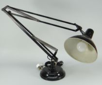 A Jacob Jacobsen mid-century architect's angle-poise lamp in black enamel on a circular base (BBC