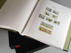 Three neat Stanley Gibbon cased folders of Isle of Man stamps with well populated contents Condition