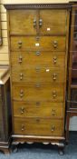 A good vintage narrow combination chest of six drawers and two-door cupboard having a dentil
