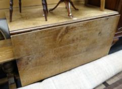 A late nineteenth century drop flap oak table, 109cms wide Condition reports provided on request