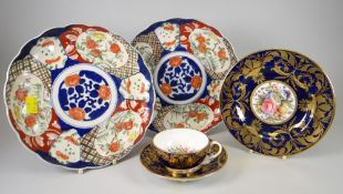 A Crown Derby porcelain trio hand painted with wild flowers to the centre of cup, saucer and plate