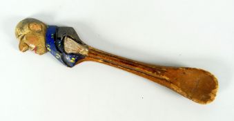A primitive folk art-type painted wooden spoon, the terminal carved as a bald headed gent in profile